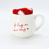 A Hug in a Mug Gift Set displaying a ceramic mug with a heartfelt message, complemented by a pair of cozy socks, ideal for warmth and comfort.