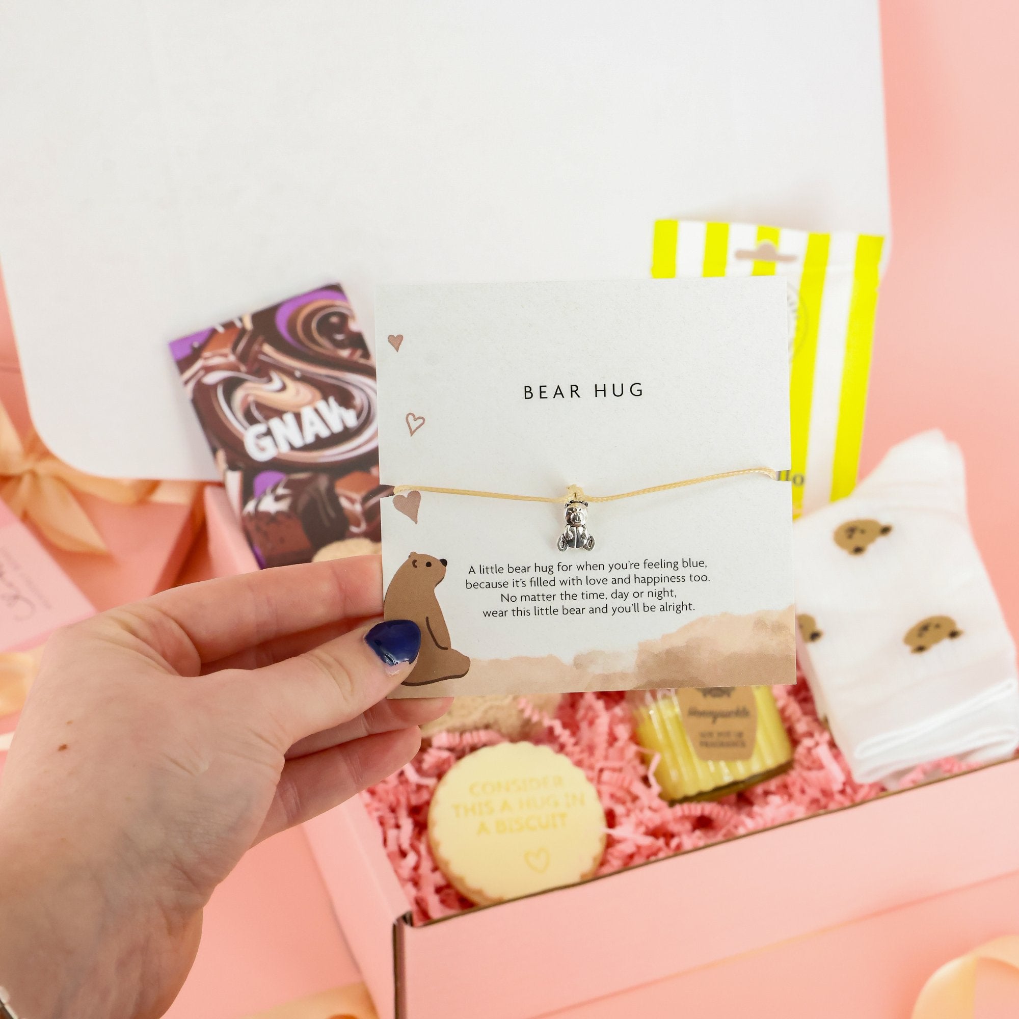 "Bear Hug" charm bracelet and sentimental card for long-distance gifting, featured in a luxury self-care hamper.
