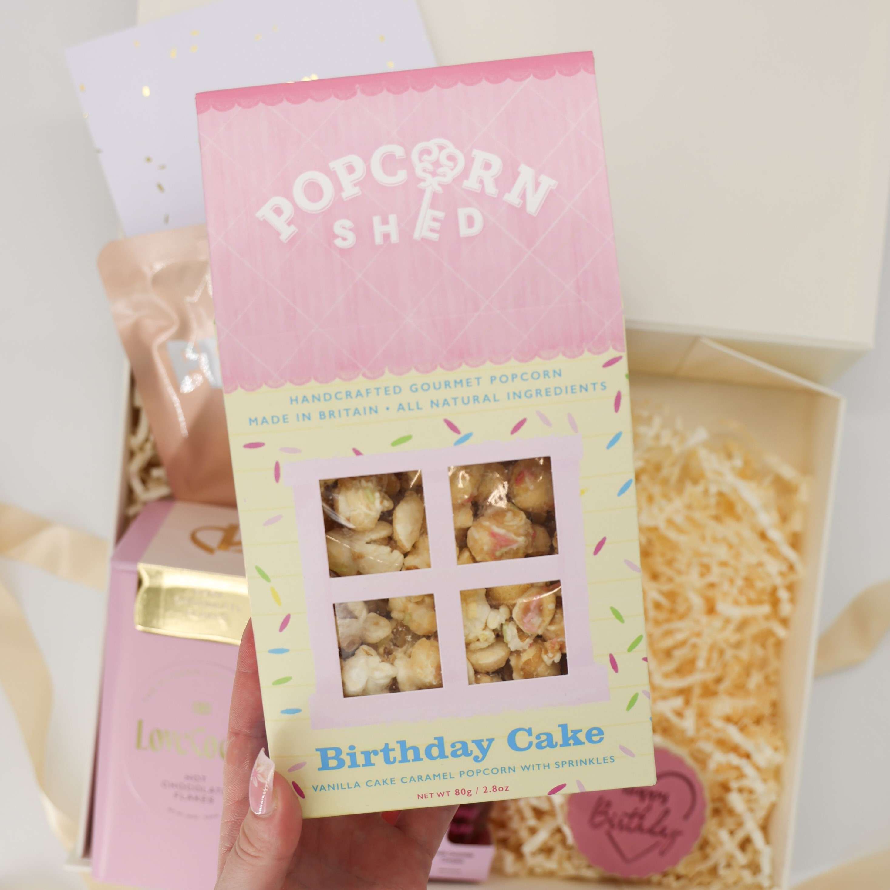 Birthday gifts for women – Pink Pamper Box featuring hot chocolate, face mask, and luxe pink touches