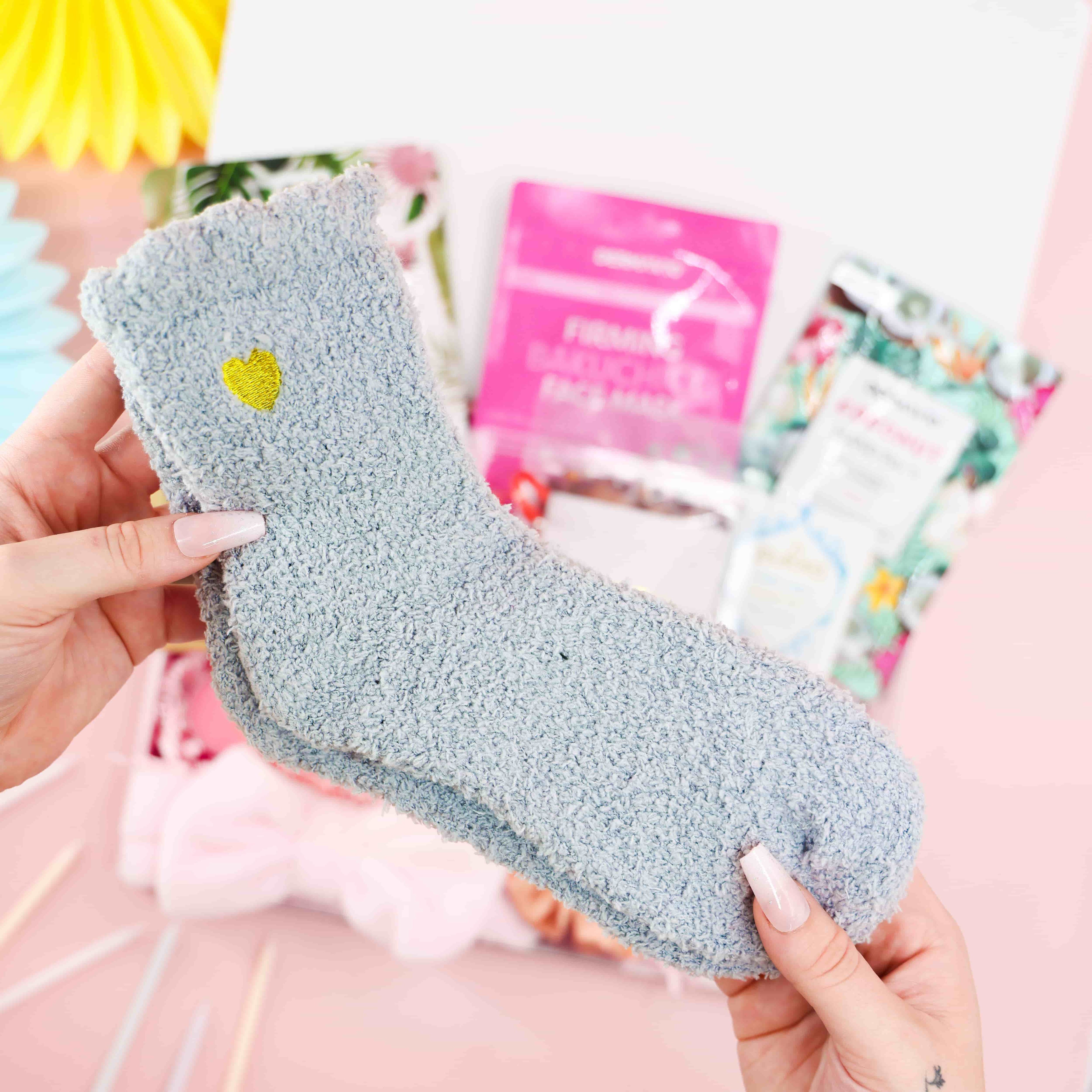 Close-up of fluffy grey heart-embroidered socks from the Birthday Spa Day in a Box – cosy self-care birthday gift for her