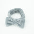 Bowknot Headband Grey: Plush headband with a stylish bow, ideal for holding hair in place during beauty routines, combining functionality and fashion.