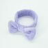 Bowknot Headband Purple: A plush, stylish headband with a bow, perfect for securing hair during beauty routines, blending functionality with fashion.