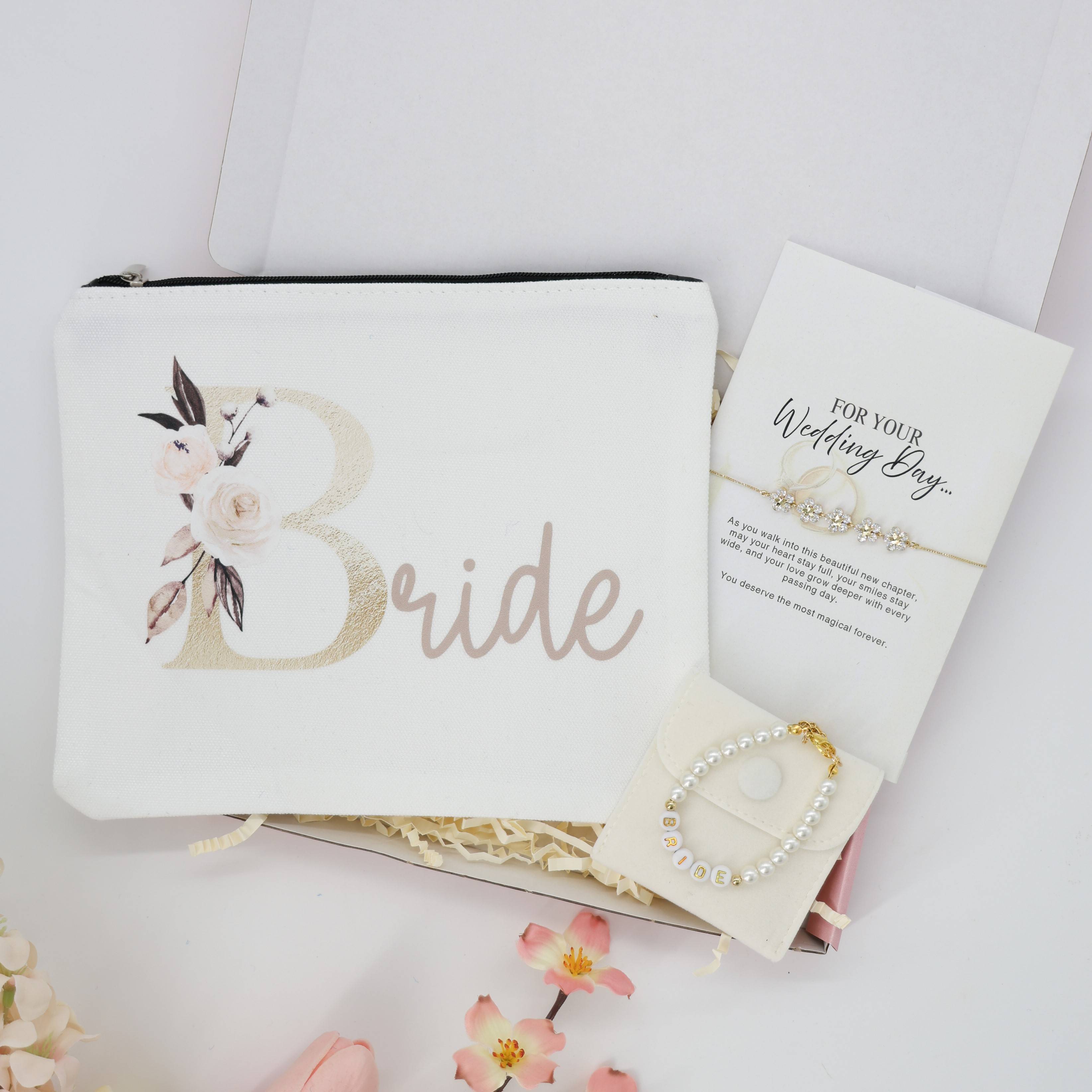 A Little Gift for the Bride | Bride To Be Gifts set with a floral pouch, pearl bracelet, and message card, elegantly arranged with floral accents.