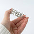Hand holding Bride Rhinestone Hair Clip, a sparkling fashion accessory, perfect for pre-wedding events, enhancing bridal celebrations with elegance and charm.