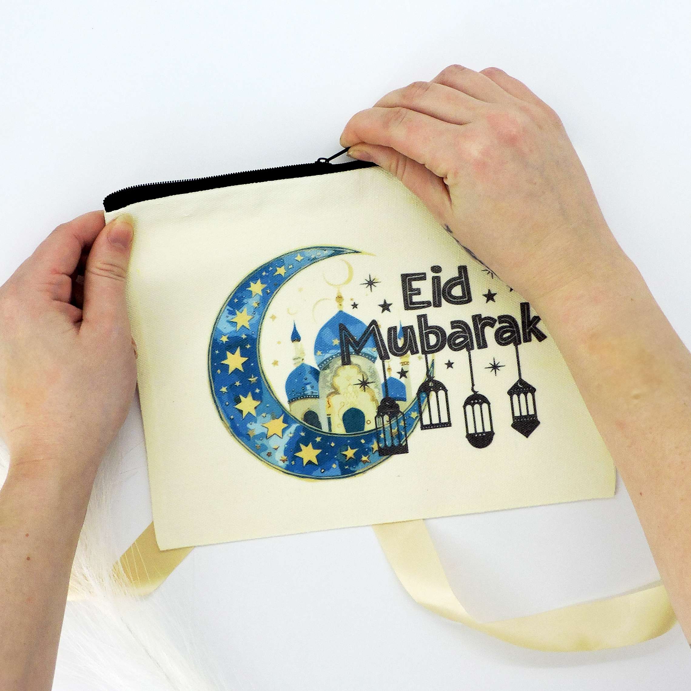 Eid Mubarak Canvas Pouch with crescent moon and lantern design, held by a person, perfect for storing essentials or gifting during Eid.
