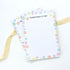 Everything is Fine A5 Deskpad with colorful smiley face border, ideal for notes and reminders, perfect for adding a cheerful touch to any workspace.