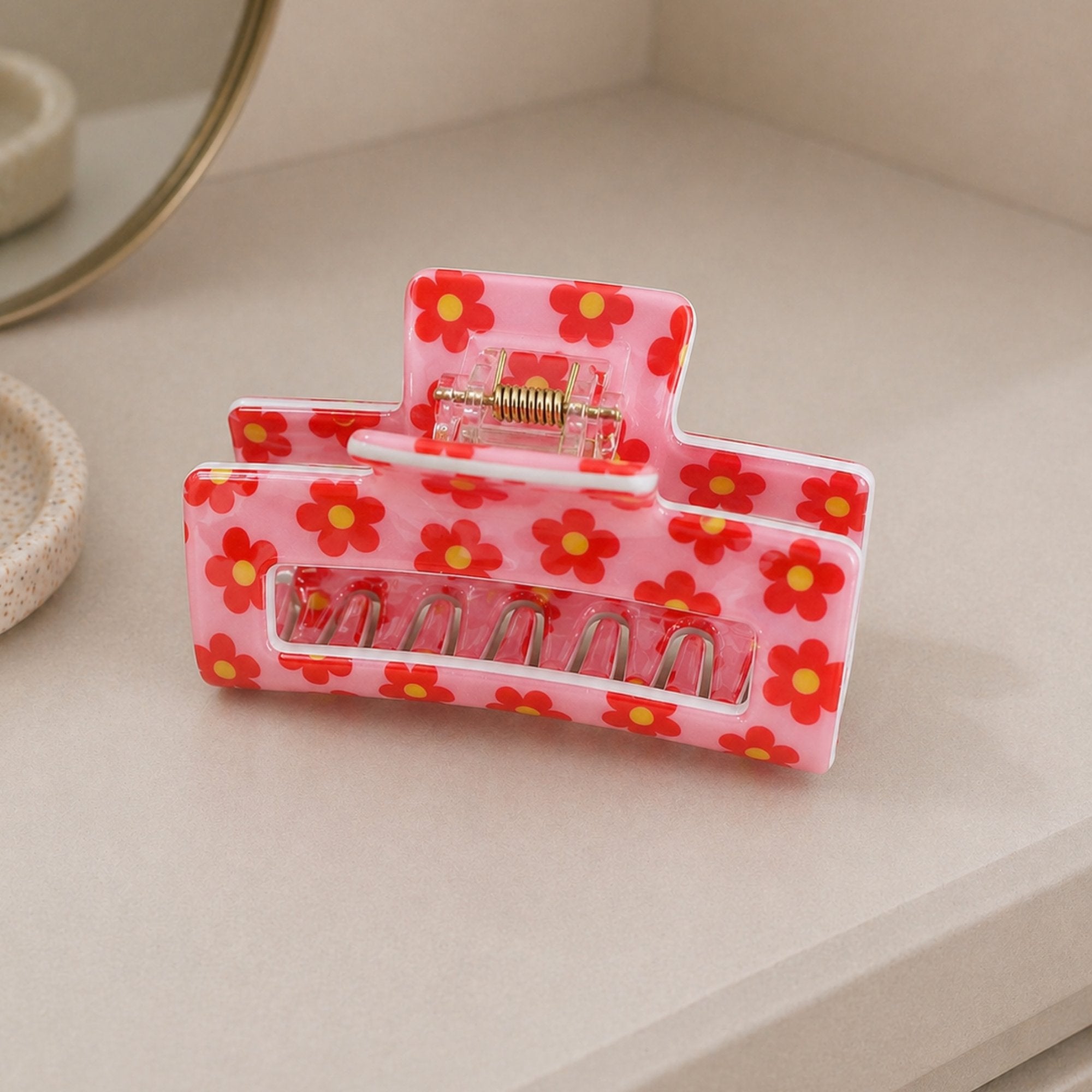 Pink & Red Floral Print Hair Clip showcasing vibrant floral patterns with a sturdy grip, ideal for adding color to any hairstyle.