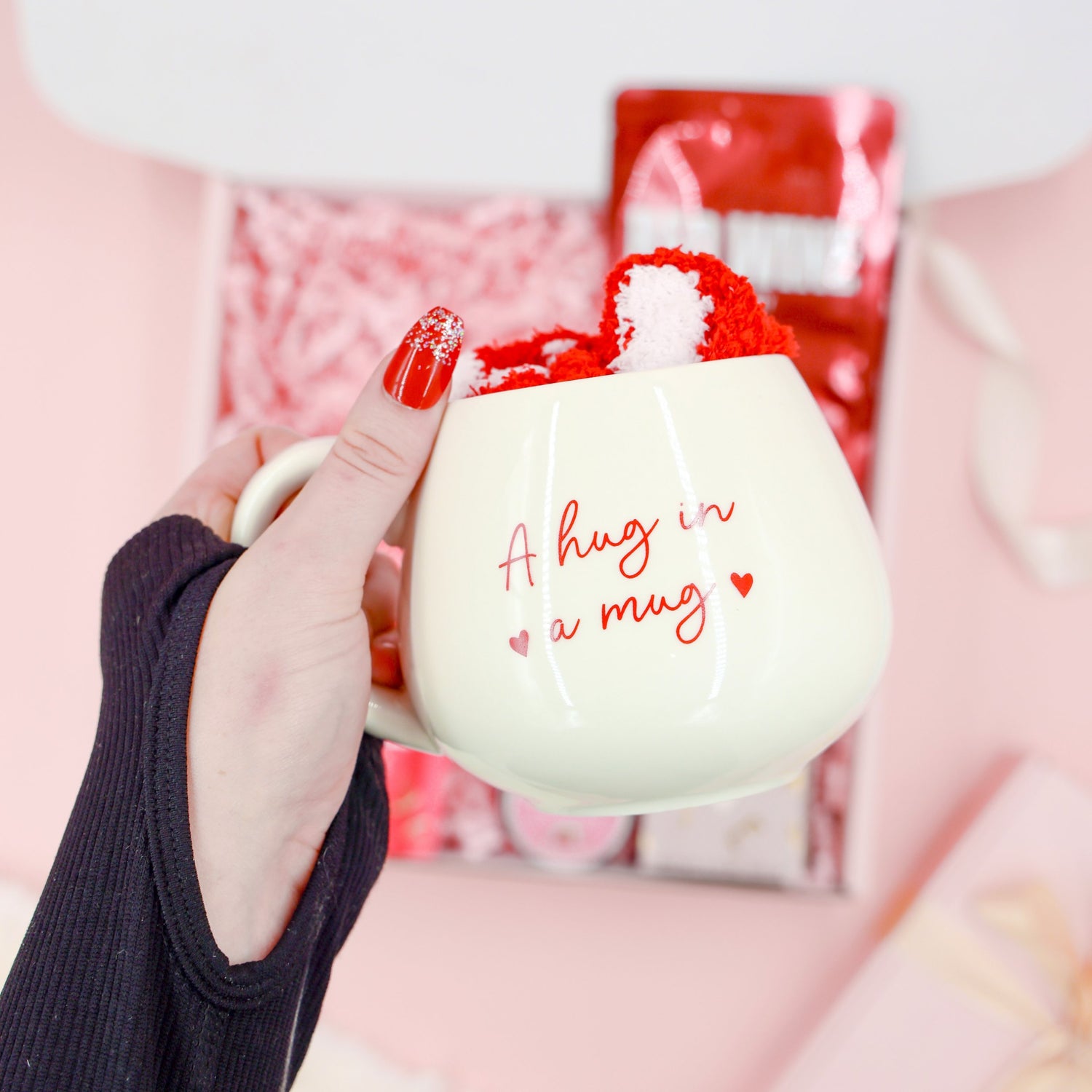 Red Velvet Treats premium gift for her – exclusive pamper hamper with Hug in a Mug cup, cosy socks, red wine face mask and indulgent chocolate.