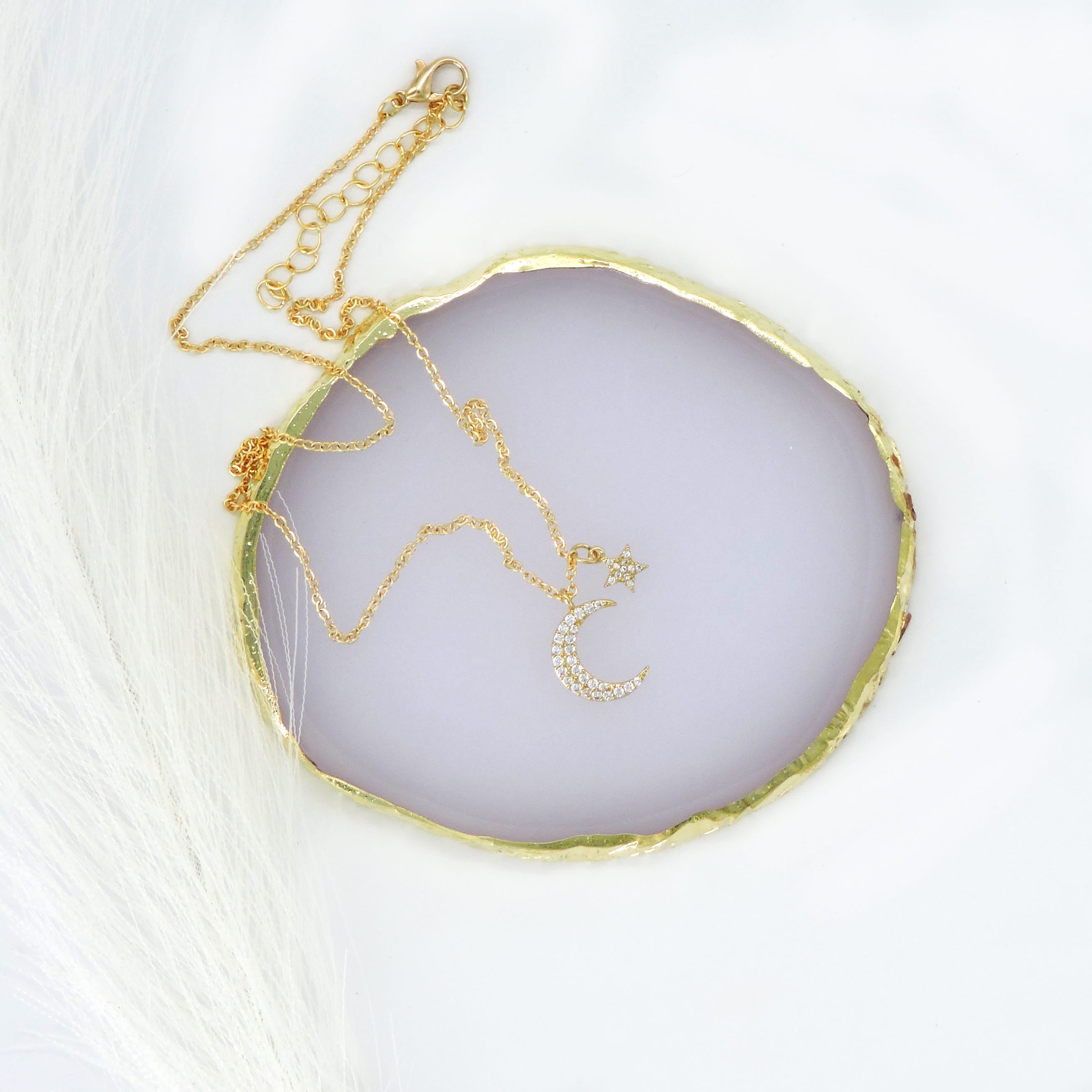 Gold Crescent & Star Necklace with a sparkling crystal-adorned pendant, featuring a crescent moon and star, ideal for adding elegance to any outfit.