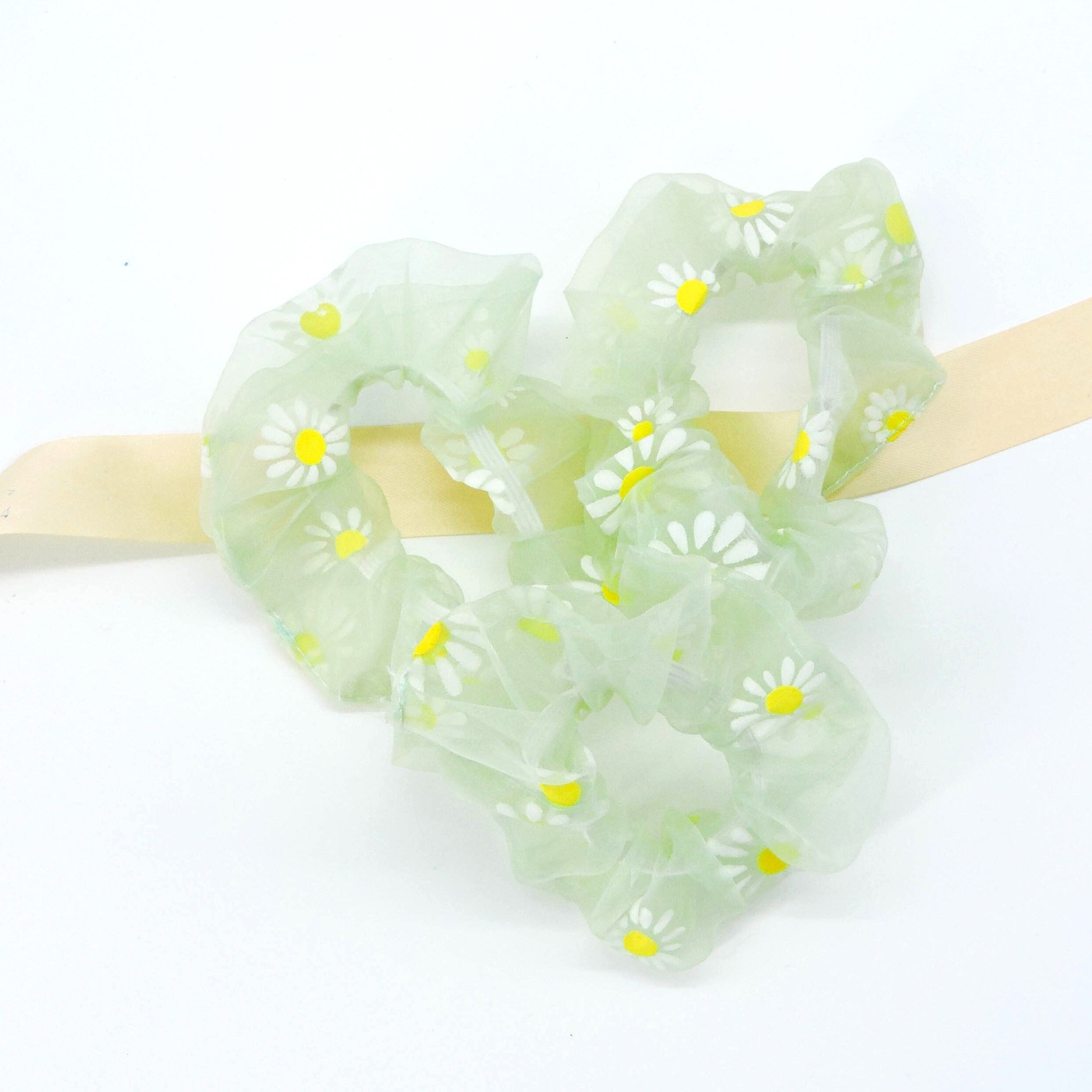 Green Daisy Hair Scrunchie showcasing delicate floral patterns, ideal for adding effortless charm and elegance to any hairstyle. Soft, lightweight, and perfect for versatile styling.