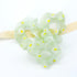 Green Daisy Hair Scrunchie showcasing delicate floral patterns, ideal for adding effortless charm and elegance to any hairstyle. Soft, lightweight, and perfect for versatile styling.