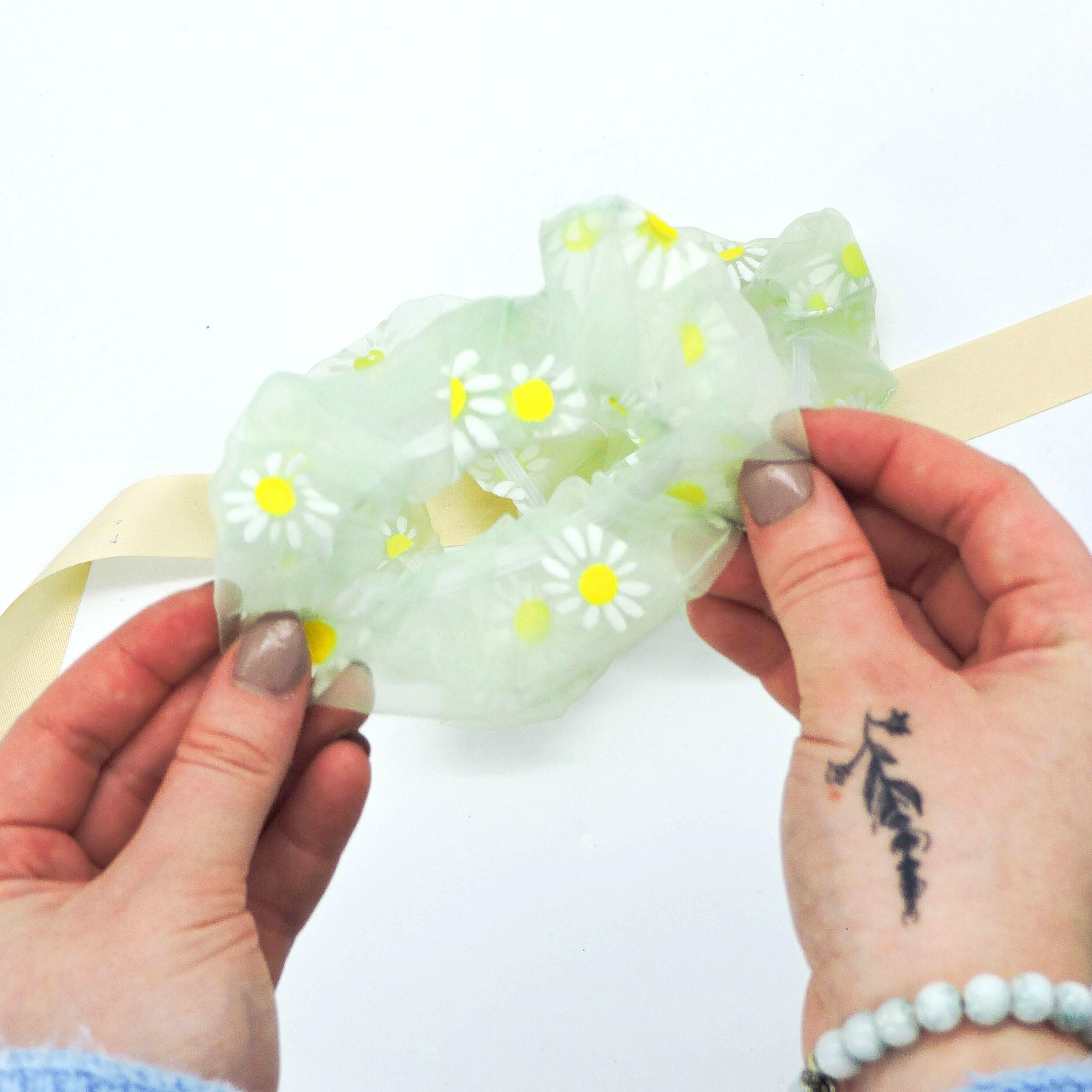 Green Daisy Hair Scrunchie, soft and lightweight, adds floral charm, shown in a person&