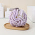 Luxury Loofah - Purple: A close-up of a textured bath loofah designed for gentle exfoliation, enhancing your bathing experience with a rich, luxurious lather.