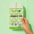 Hand holding a package of Matcha Face Mask - Hydrating & Toning, enriched with aloe vera and niacinamide, perfect for at-home spa treatments.
