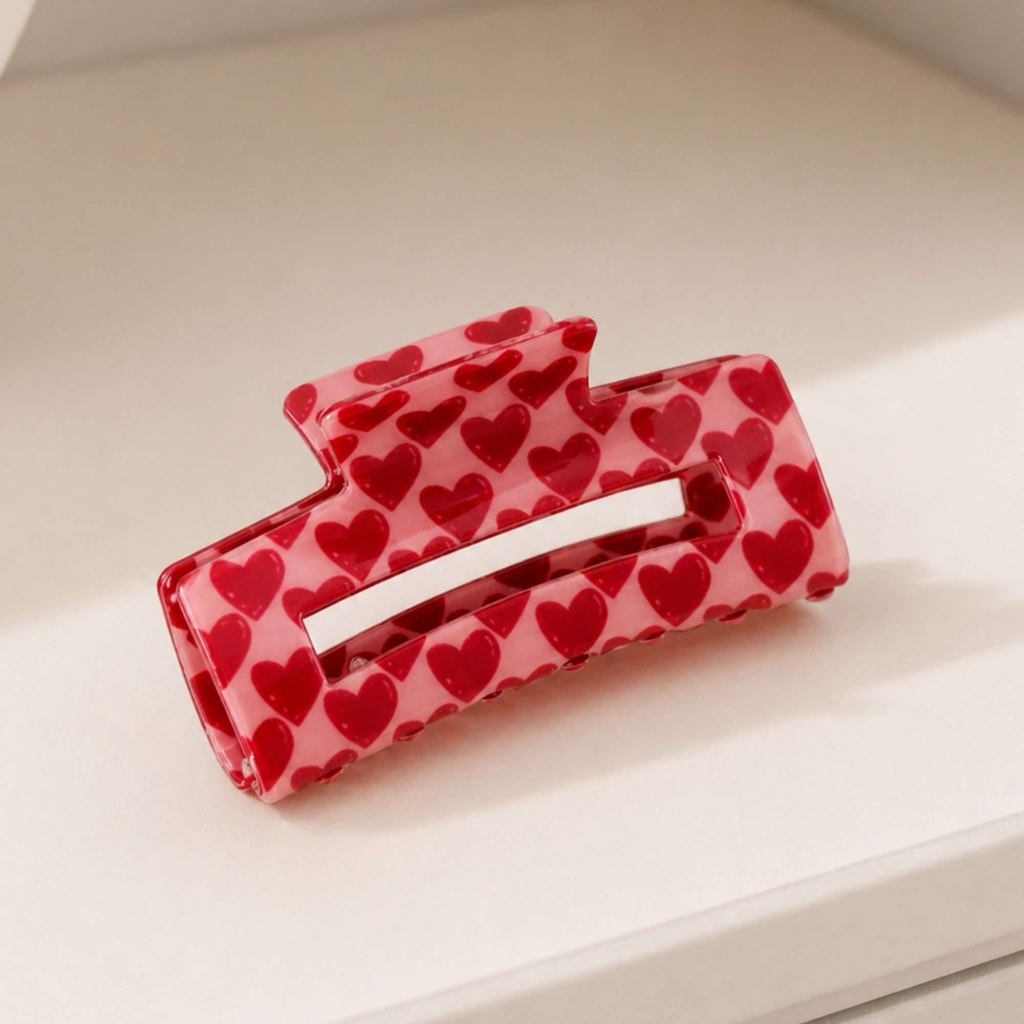 Pink Heart Hair Clip featuring a bold heart pattern, designed for style and durability, perfect for everyday wear or as a thoughtful gift.