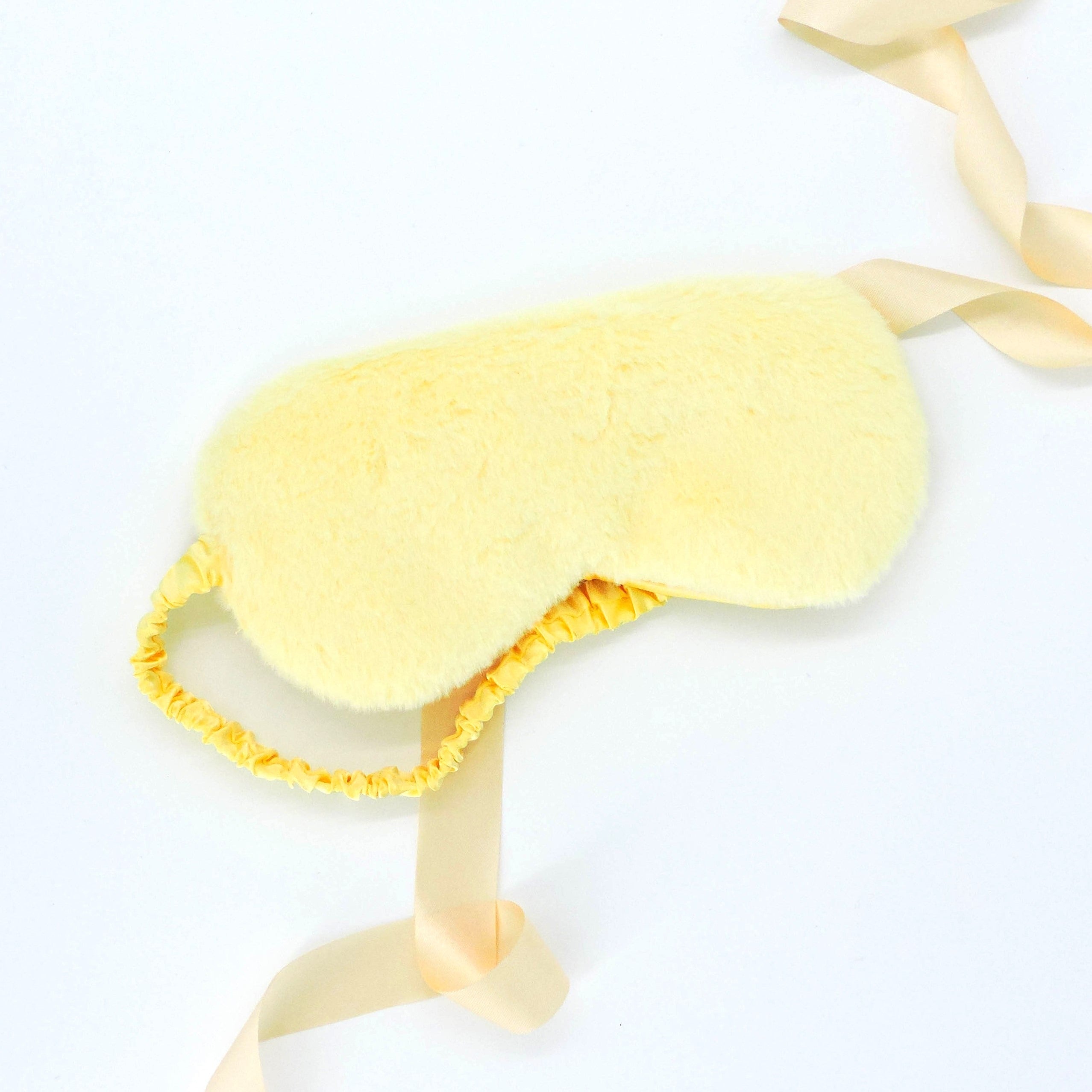 Plush Eye Mask - Yellow, featuring an ultra-soft texture and secure fit, ideal for blocking light and enhancing sleep comfort.