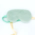 Plush Eye Mask - Green: A close-up of a plush sleep mask with a yellow ribbon, featuring a satin strap for a comfortable fit.