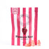 Prosecco Rose Gummies - Non Alcoholic; close-up of pink flower-shaped gummies with a label and logo, featuring fruity notes of strawberries, cherries, and raspberry.
