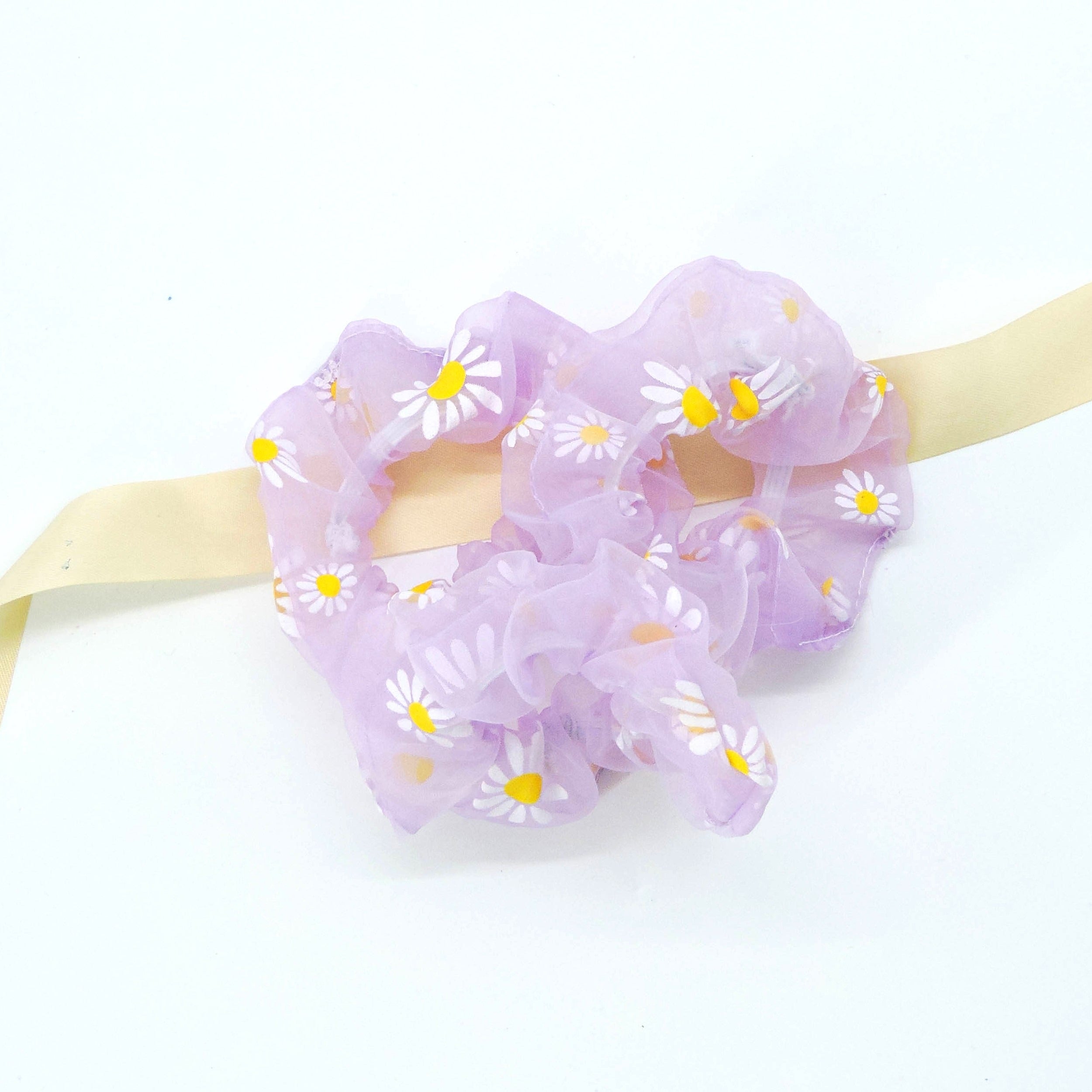 Daisy Hair Scrunchie - Purple: A purple organza scrunchie adorned with white daisies, offering a lightweight and elegant hold for various hairstyles.