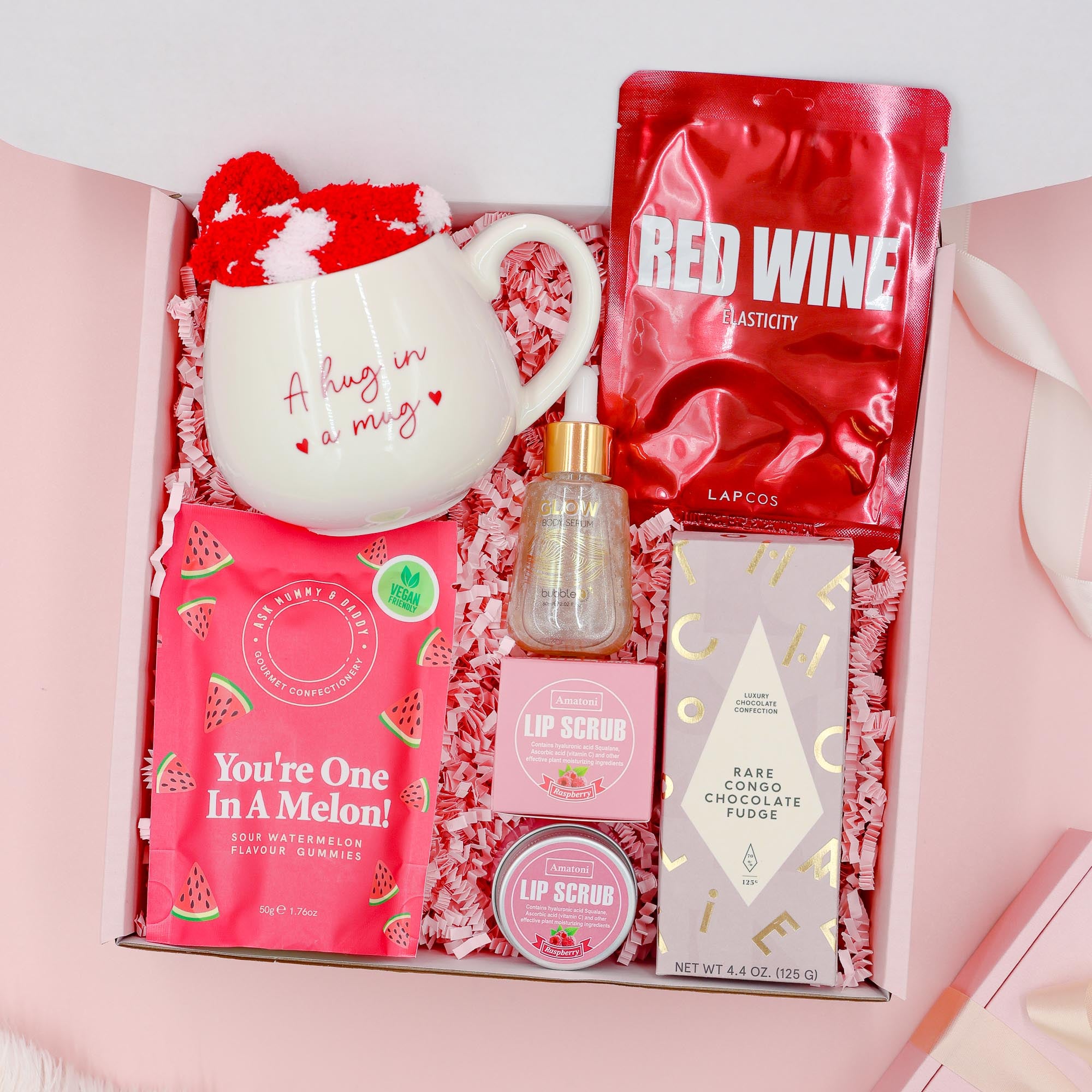 Red Velvet Treats exclusive luxury gift for her with premium chocolate, red wine face mask, Hug in a Mug cup, cosy socks, gummies and lip scrubs.