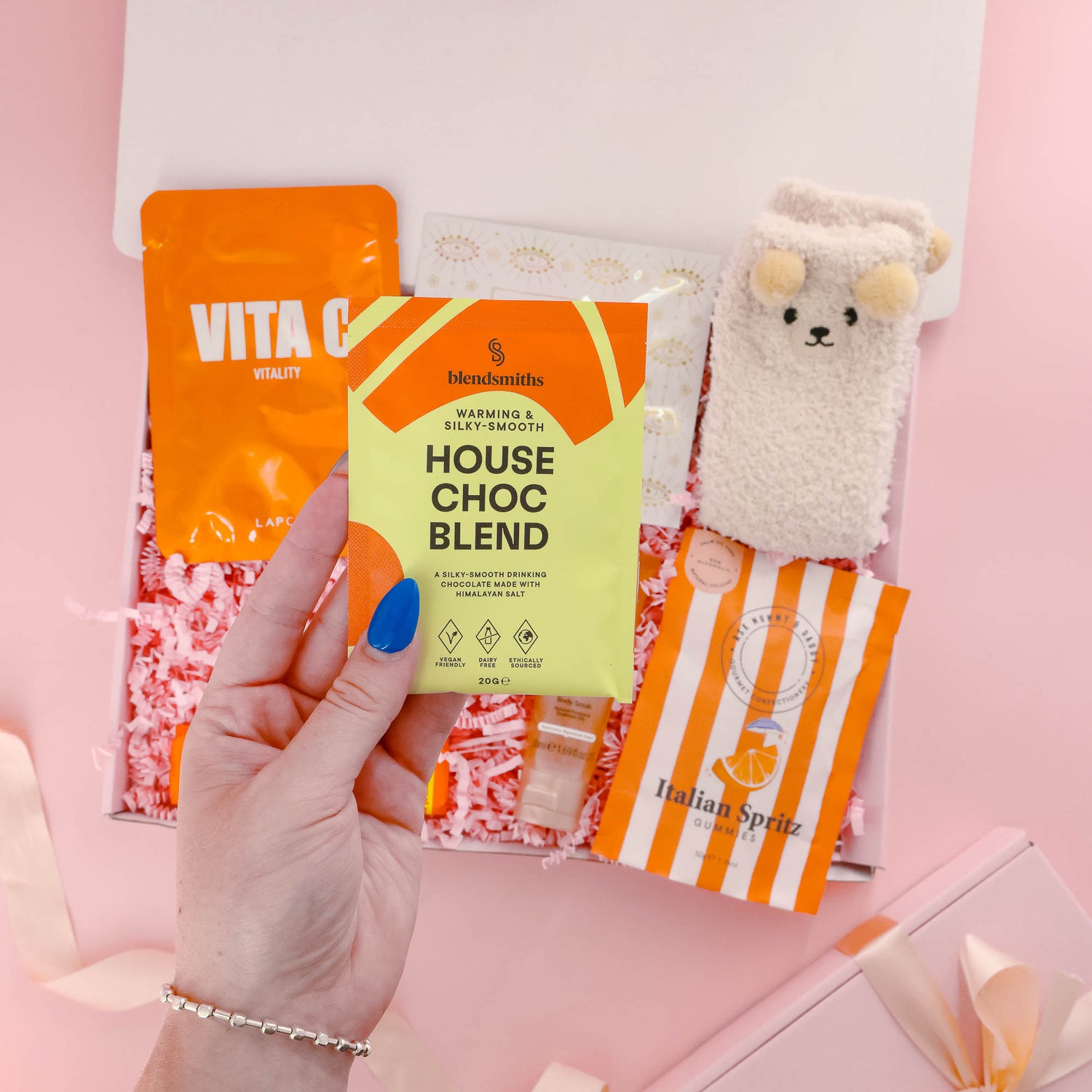 Comforting self care gift box for her with warming hot chocolate blend, bear socks, pamper mask, eye mask and indulgent sweet treats.