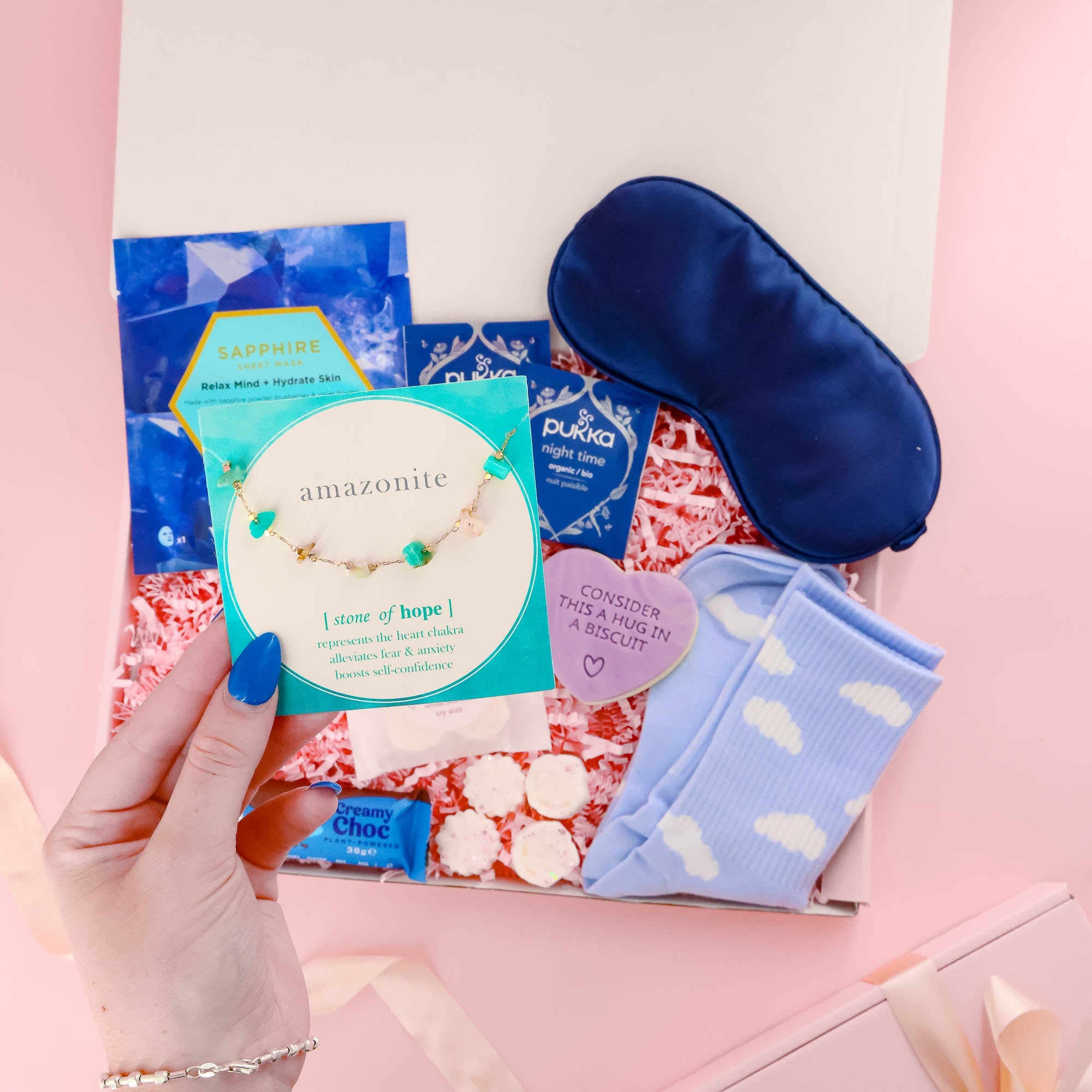 Luxury pamper gift for her featuring a calming amazonite bracelet, herbal teas, sleep essentials, and relaxing skincare – ideal for a self care night in.