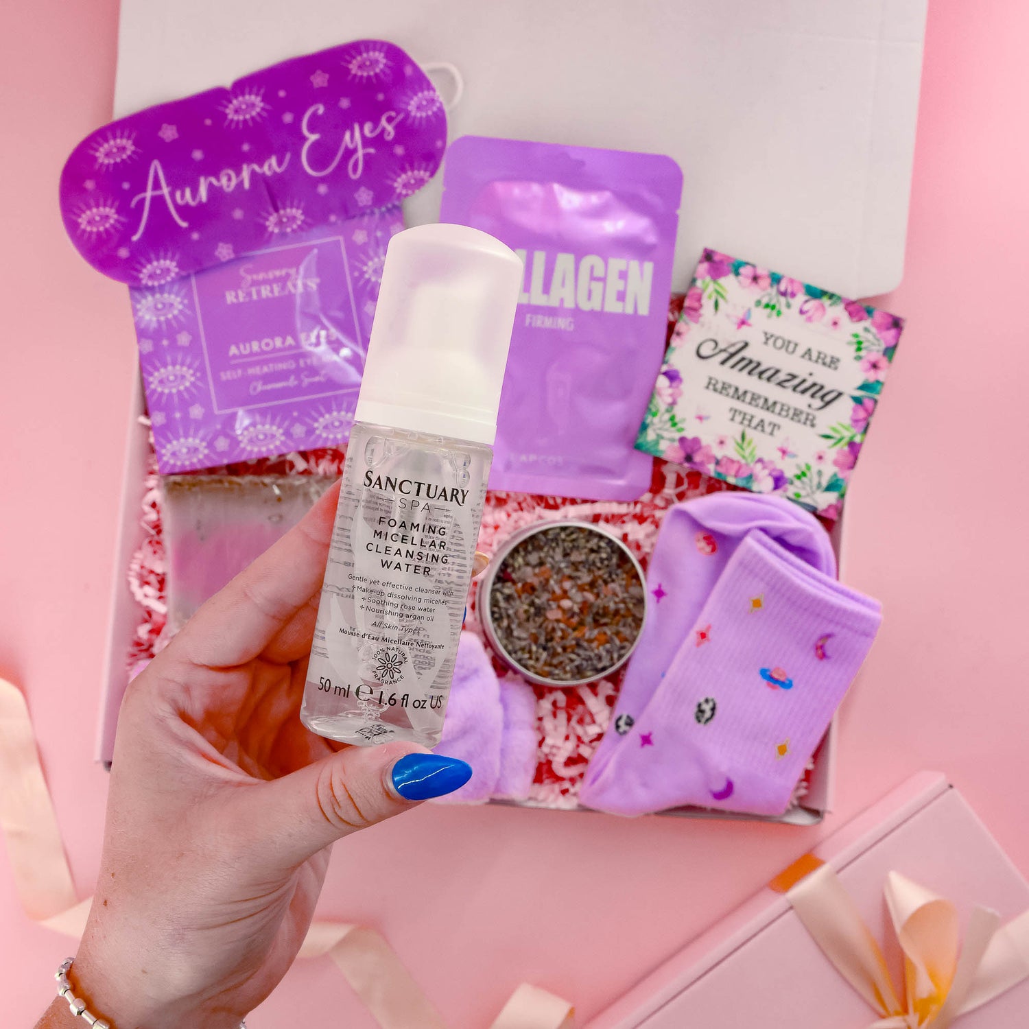 Selfcare gift for her with Sanctuary Spa cleansing water, collagen face mask, eye mask, socks, and pamper treats a relaxing gift box for women.