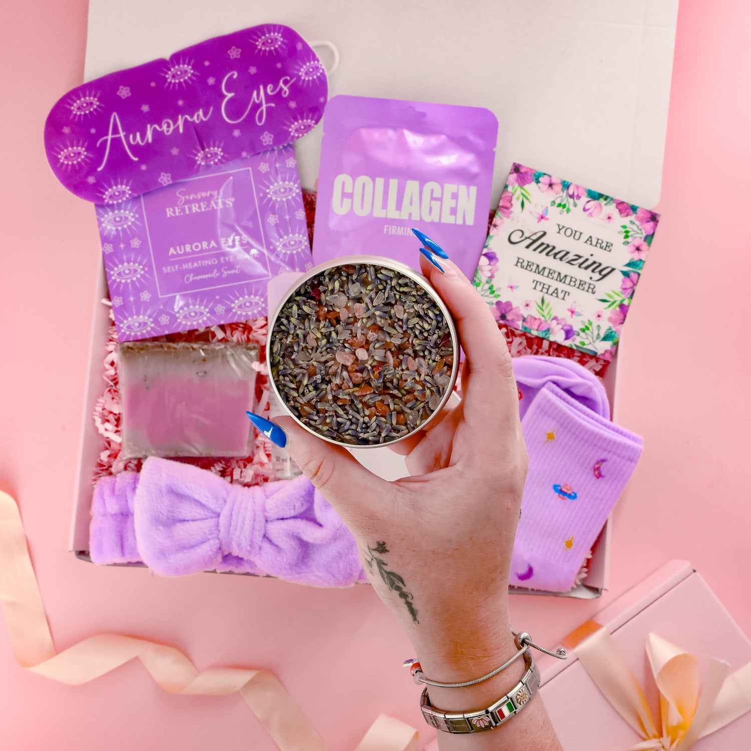 Luxury selfcare gift for her with herbal bath salts, spa skincare, face mask, purple socks and relaxing eye mask ideal for stress relief and pampering.