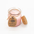 Yasmine Wings Candle close-up, showcasing its elegant floral fragrance and compact size, ideal for gifting. Visible cork lid and packaging enhance its sophisticated presentation.