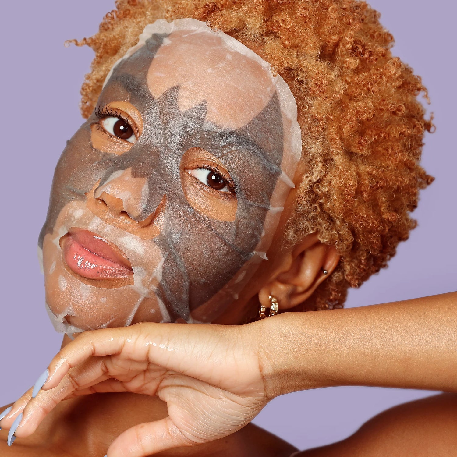 Woman applying a face mask with a halloween theme from heavenly boxes