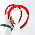 Sponge Pearl Hairband Set - 3pcs Red featuring a hand holding a string of pearls, showcasing the delicate pearl-accented headband from the collection.