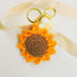 Sunflower Crochet Keyring, a handmade accessory, features a detailed crochet flower. Ideal for adding charm to keys or bags, perfect for sunflower enthusiasts.