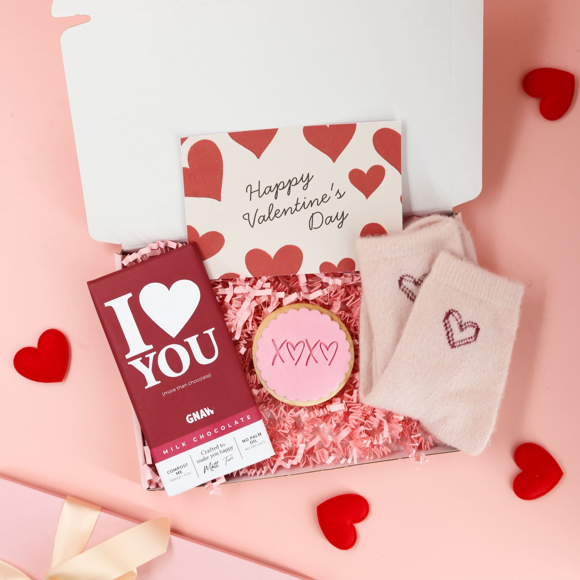 Valentines gift for her letterbox box featuring cosy socks, sweet treats and pink packaging