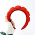 Hand holding the Velvet Headband - Red, highlighting its soft polyester texture, perfect for adding elegance to everyday hairstyles or beauty routines.