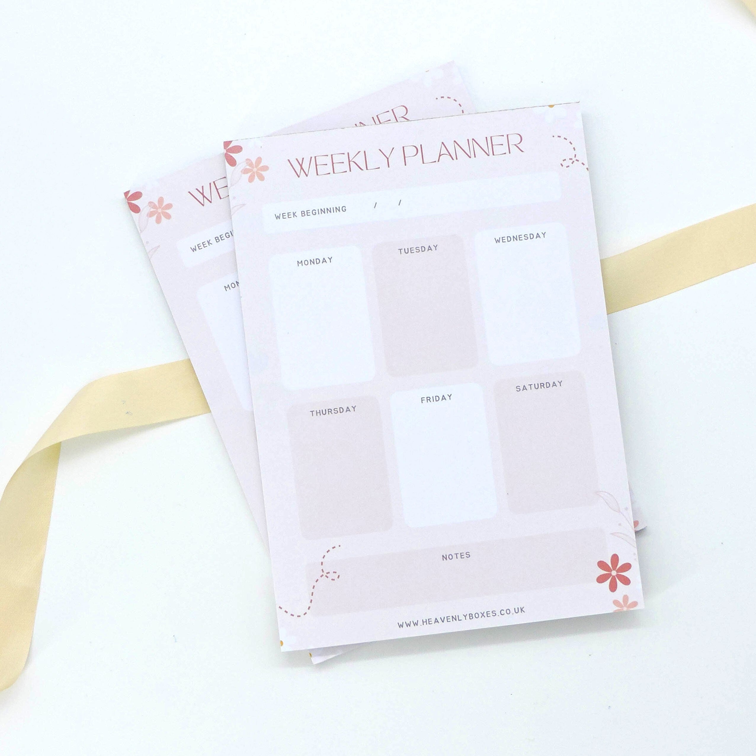 Weekly Planner - A5 Deskpad featuring elegant handwriting and a visible white label, perfect for organizing daily tasks and priorities with mindfulness and style.