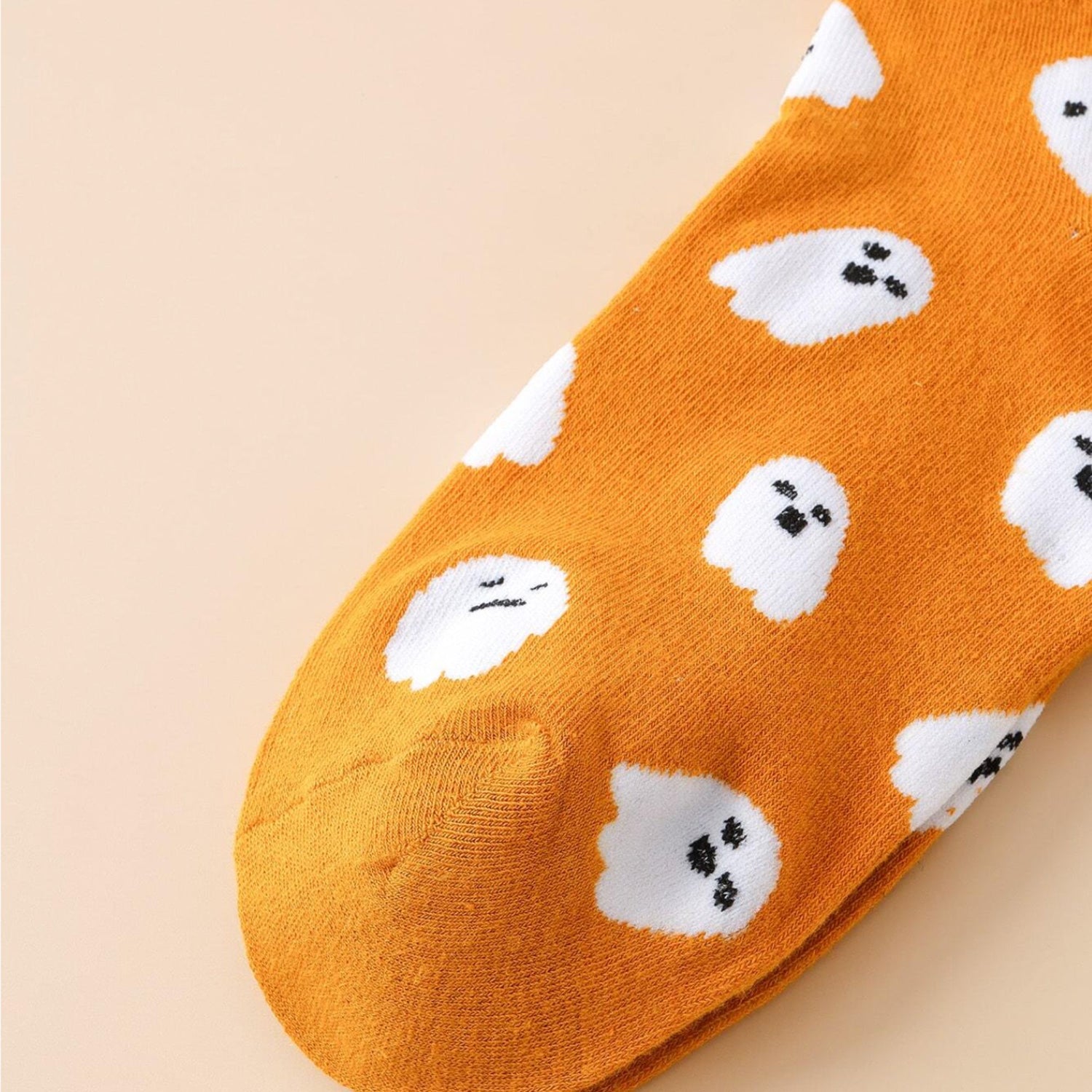 Ghost Pattern Socks featuring playful white ghosts, perfect for Halloween. Cozy mid-calf design adds a quirky touch to any outfit.