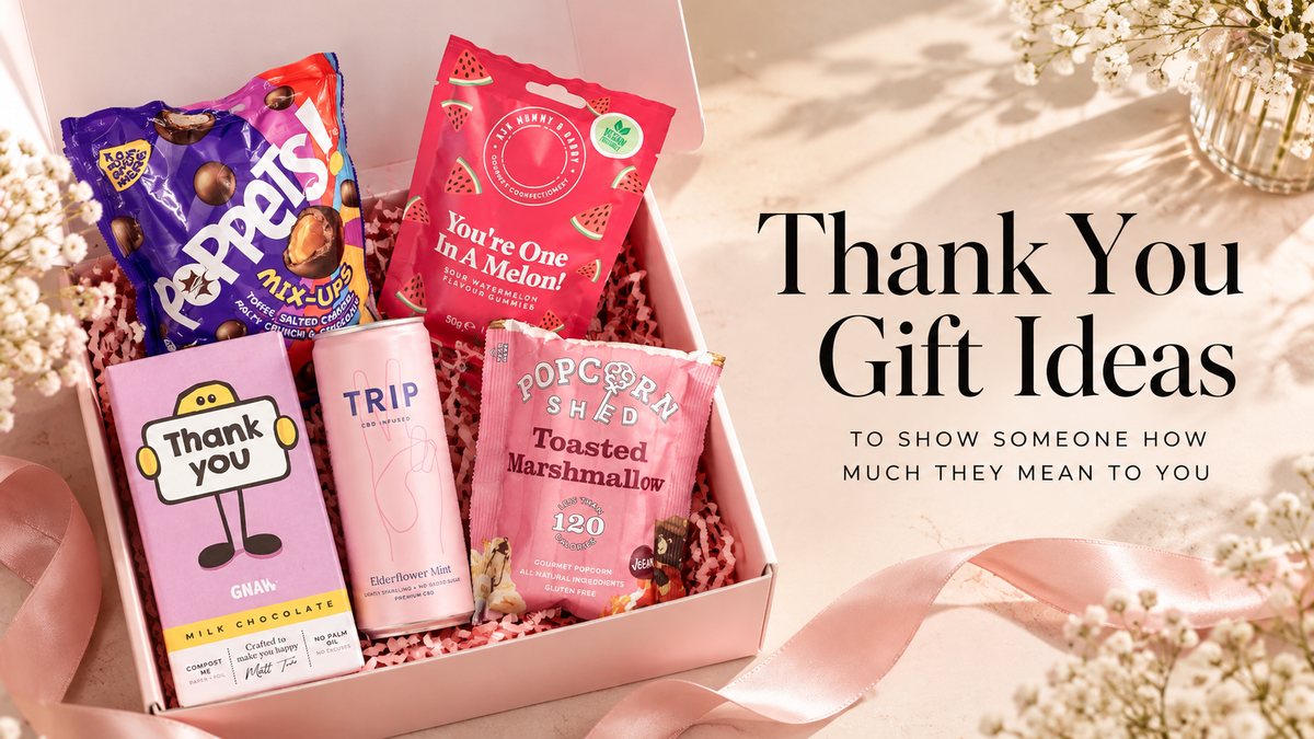 Thank you gift box from Heavenly Boxes UK featuring chocolates, sweet treats, popcorn and a refreshing drink, beautifully presented in pink packaging.