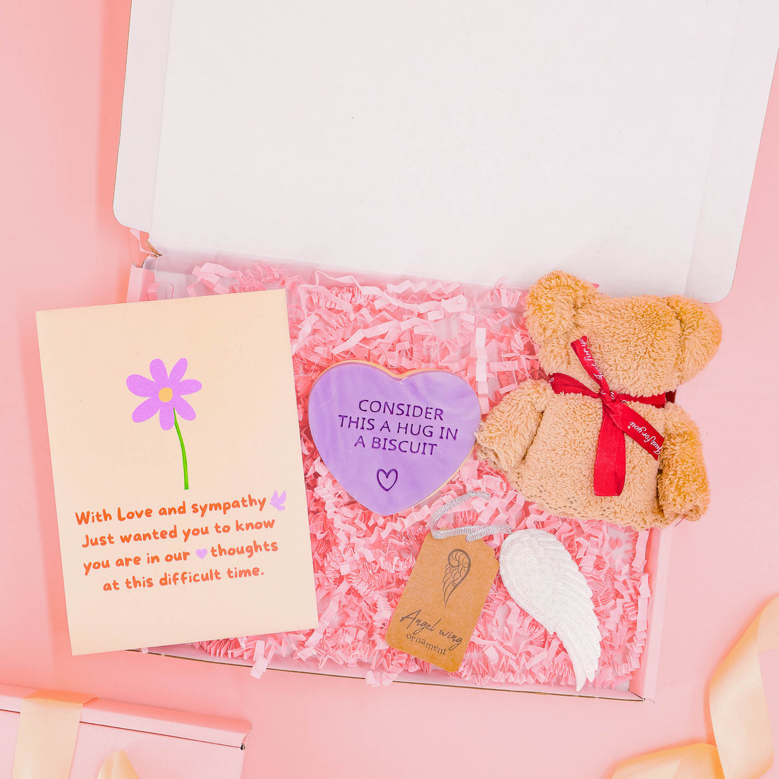 Sympathy and bereavement gift for her including a plush teddy, heart biscuit, angel wing keepsake, and heartfelt card – a gentle gift to show you care.