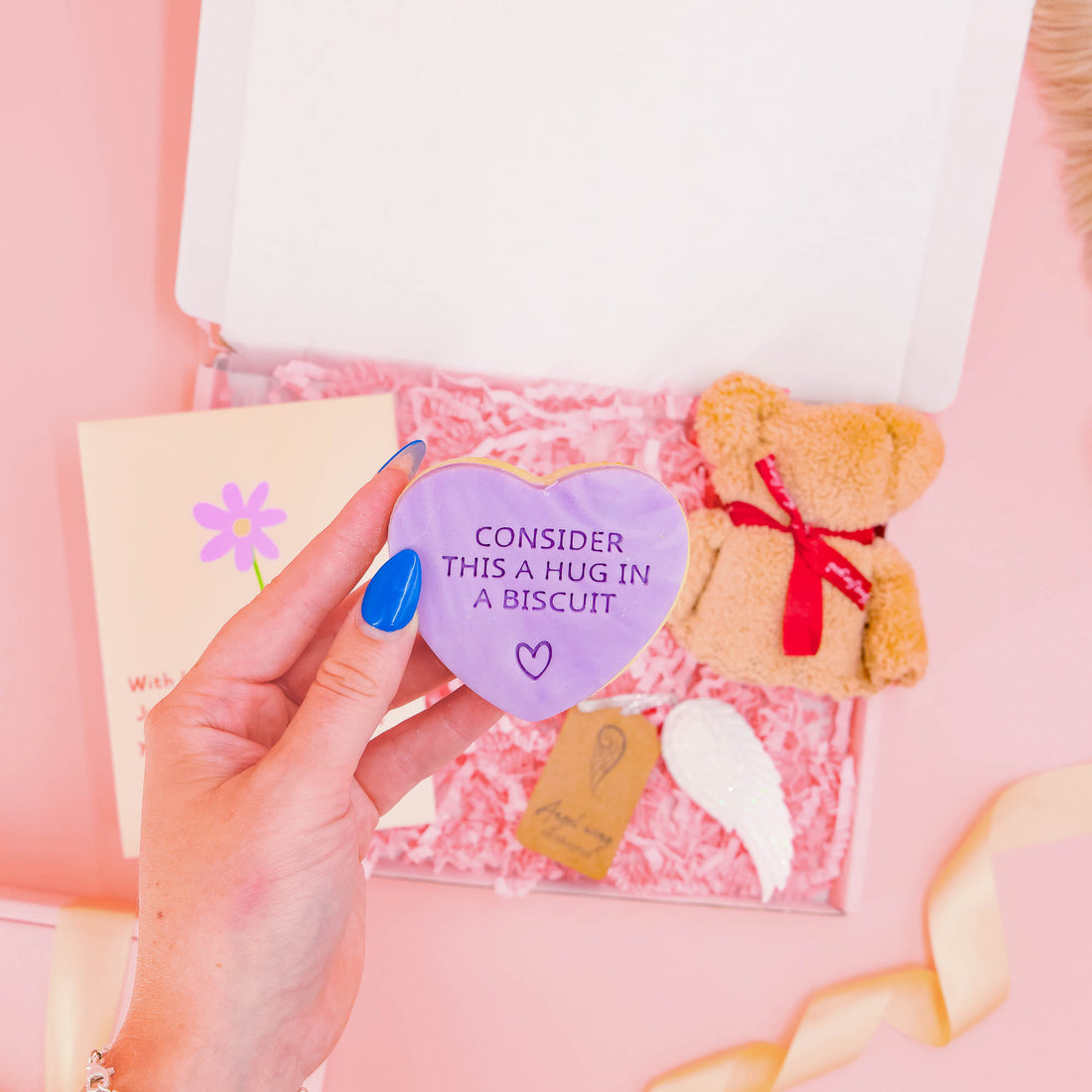 Meaningful bereavement gift box for her with a heart-shaped “hug in a biscuit”, plush bear, angel wing ornament, and sympathy card – sent with love.
