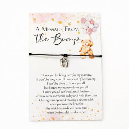 A Message from the Bump Bracelet featuring a delicate bracelet with a tiny baby feet charm on a message card, symbolizing motherhood excitement.