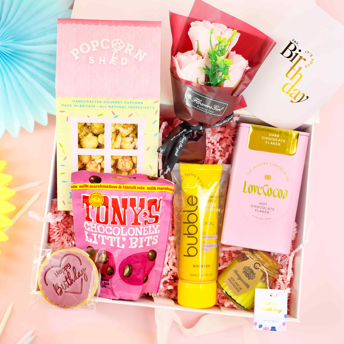 A Pretty Pink Birthday Gift Box – pink limited-edition birthday hamper with Love Cocoa hot chocolate flakes, popcorn, Tony’s chocolate, body lotion and birthday biscuit by Heavenly Boxes.