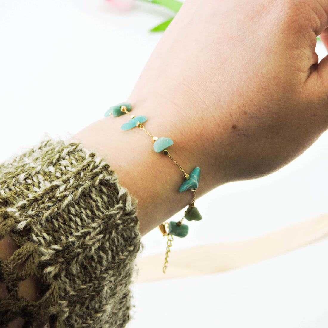 Close-up of the Amazonite Stone of Hope Bracelet, showcasing raw amazonite chips on a delicate gold-tone chain, reflecting its calming and positive energy properties.