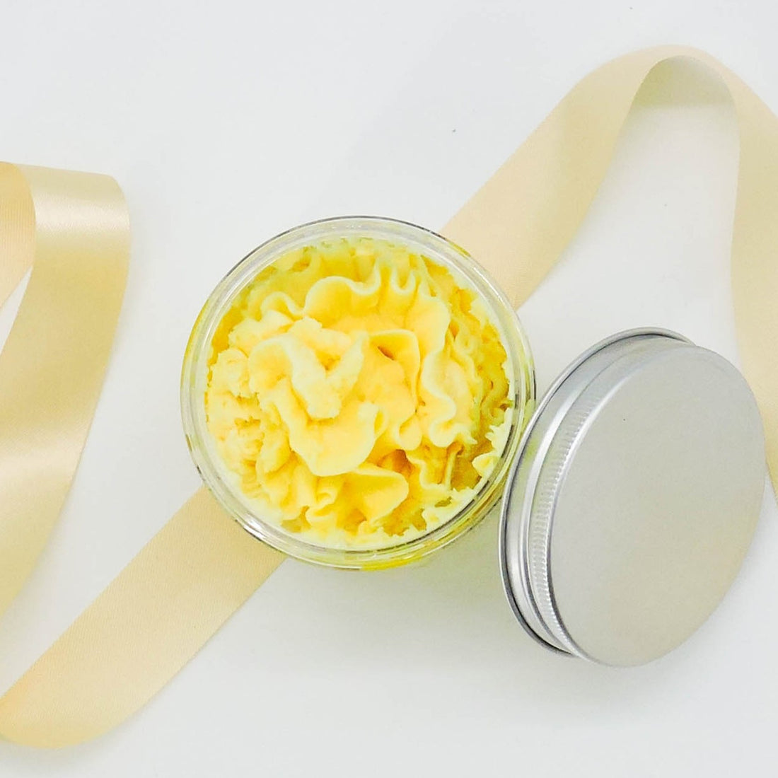 Banana Whipped Soap, a luxurious shower treat with a soft, cloud-like texture, captured in a close-up highlighting its playful, vibrant presentation.
