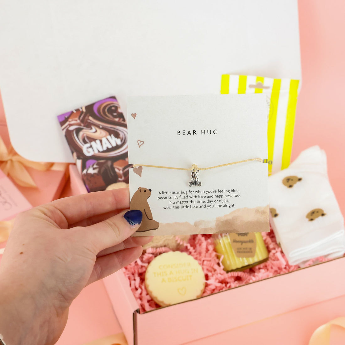 "Bear Hug" charm bracelet and sentimental card for long-distance gifting, featured in a luxury self-care hamper.