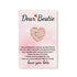 Bestie Heart Pocket Hug pin with heartfelt message, perfect for gifting. Featured amid floral close-ups, symbolizing friendship and love.