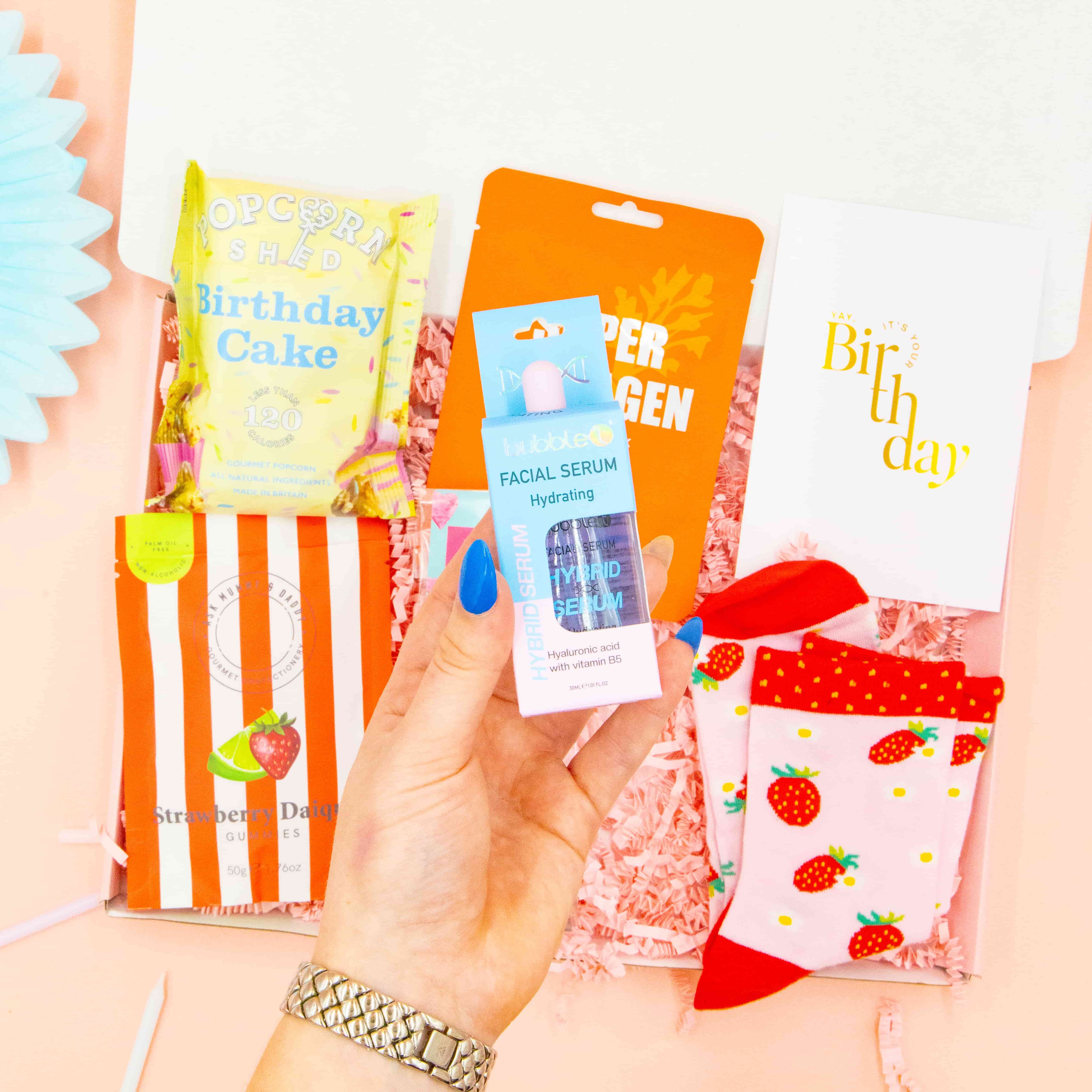Fun birthday gift for her – cosy strawberry socks, pampering mask, and chocolate spoon
