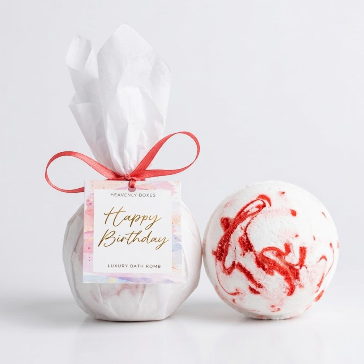 Luxury Happy Birthday Bath Bomb wrapped in white tissue with pink ribbon and birthday gift tag