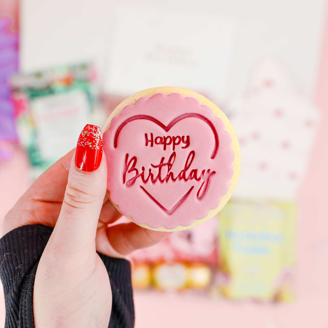Iced Happy Birthday biscuit in pink heart design – included in the Birthday Joy Box gift set.