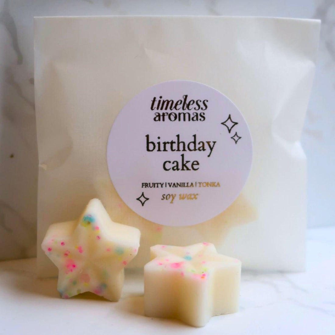 Birthday Cake Wax Melt: star-shaped soy wax melts with colorful sprinkles, exuding a rich birthday cake scent of moist white cake and buttercream frosting.