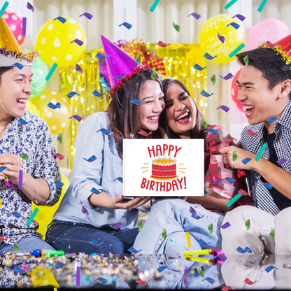 Group of friends celebrating birthday with party hats and confetti, holding a chocolate gift box that says Happy Birthday.